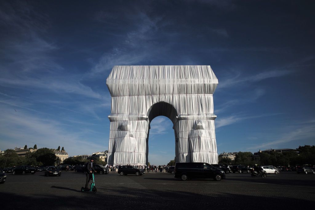 PARIS, FRANCE SEPTEMBER 22: The Arc de Triomphe wrapped in a giant sheet of fabric as part of a project of late Bulgarian-born US artist Christo Javacheff is seen on September 22, 2021 in Paris, France. The Arc de Triomphe was wrapped in 25,000 square metres of silvery recyclable polypropylene using 3,000 metres of red rope. The work, which involved 95 people, took several days to complete. Christo and his wife Jeanne-Claude earlier wrapped the Pont-Neuf in Paris, the Reichstag in Berlin and floating piers