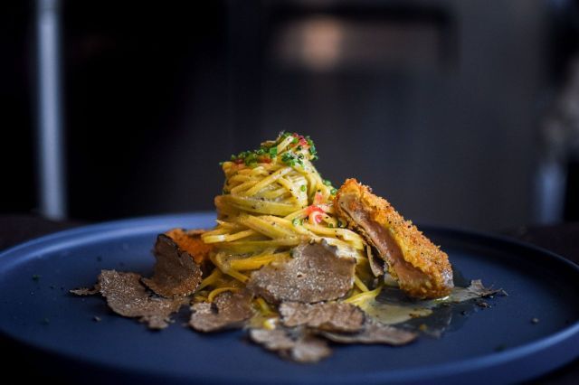 Spinach tagliatelle in truffle cacio e pepe, topped with a golden brown foie gras “nugget” (Photo: Back Alley Pasta)