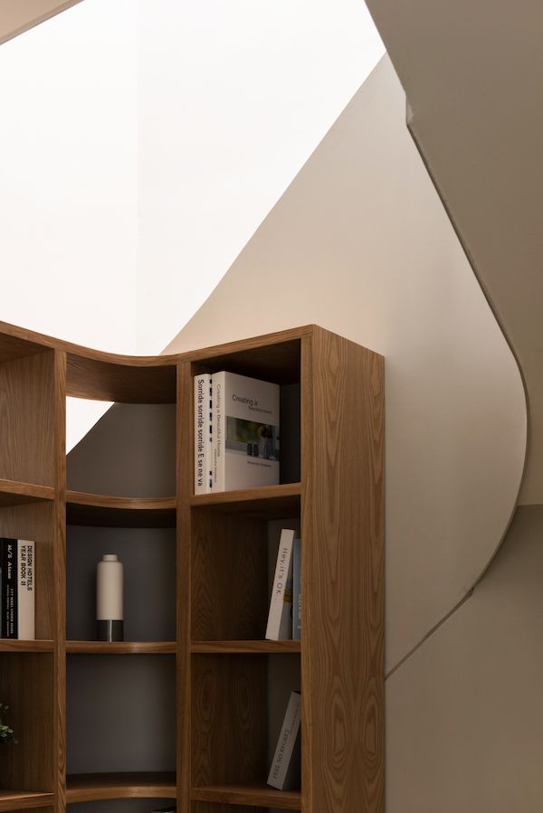 The staircase wraps around the furniture