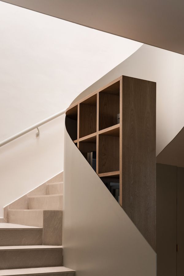 The staircase wraps around the furniture