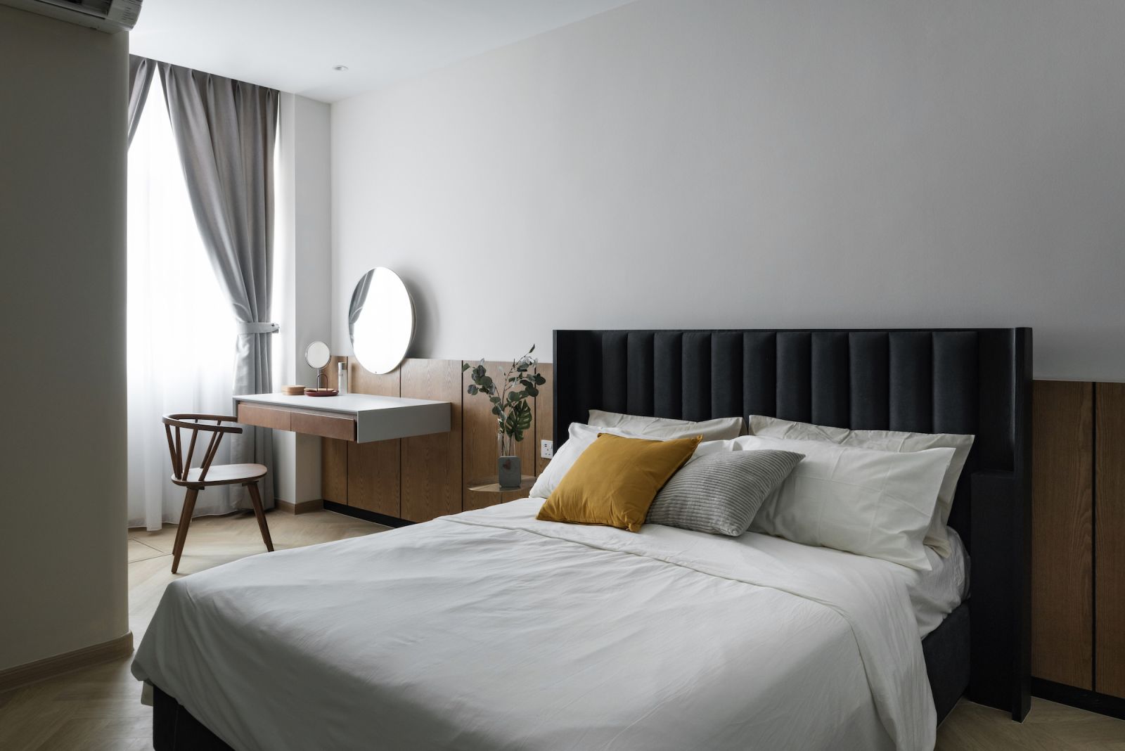 The limited colour palette of the bedroom imbues it with a serenity