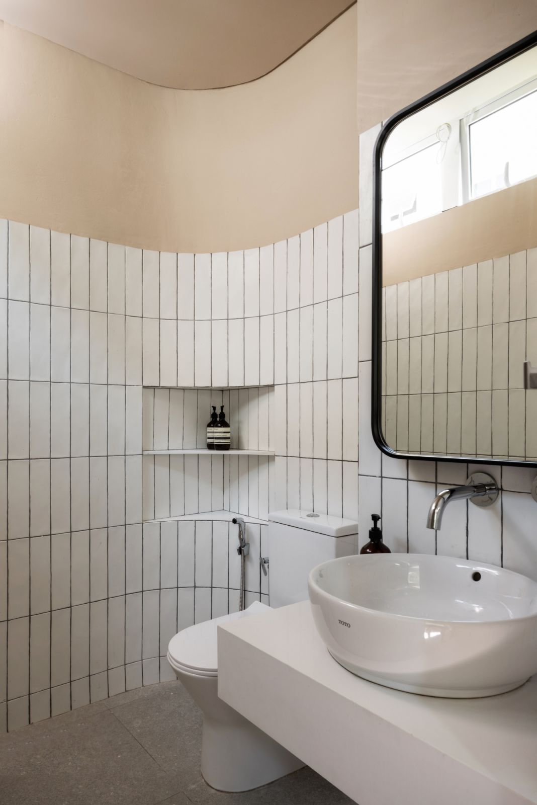 The bathroom has a curved wall
