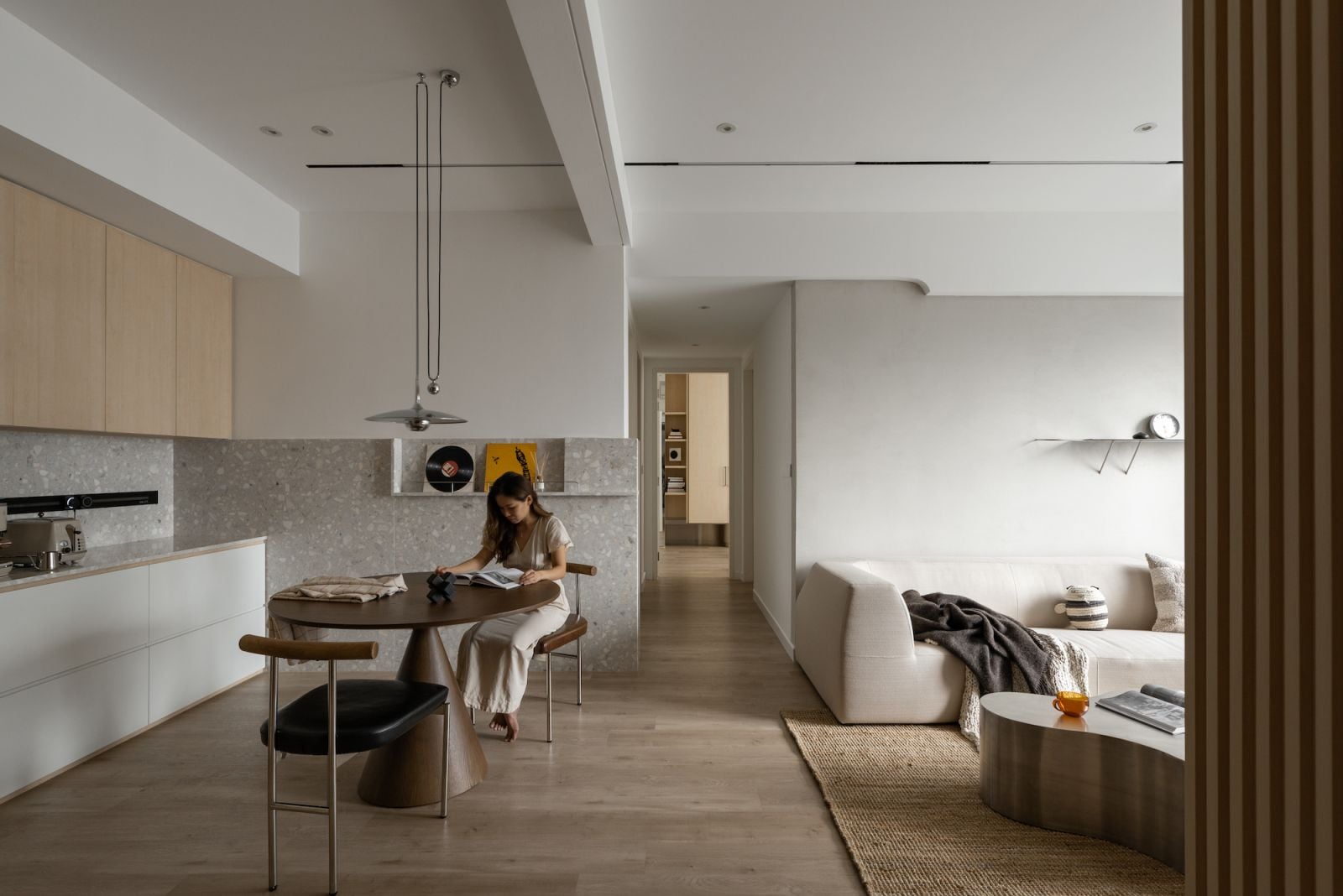 Sculptural furniture is juxtaposed against the minimalist backdrop