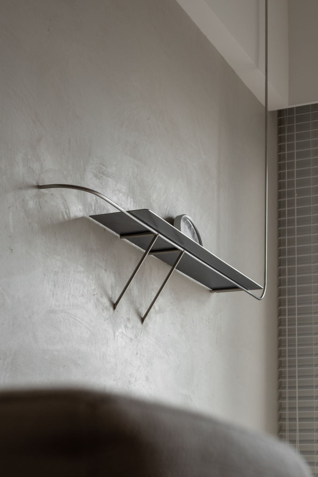 A shelf breaks up the expanse of the wall