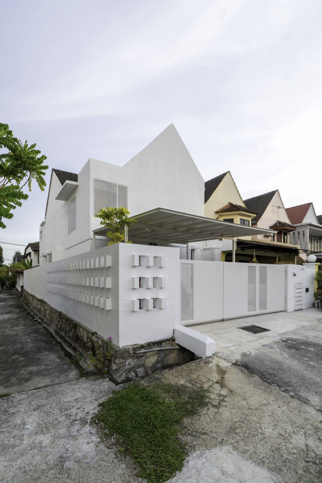 The all white facade of Insight house stands out in the neighbourhood