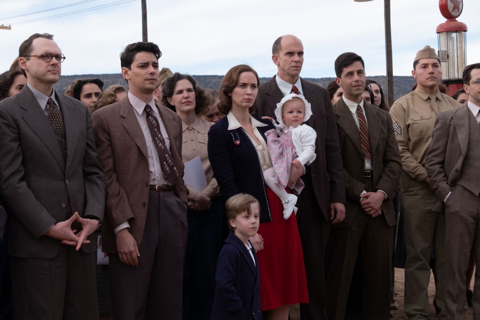 Front Row L to R: Christopher Denham as Klaus Fuchs, Seth Neddermeyer is Devon Bostick, Emily Blunt is Kitty Oppenheimer, Gustaf Skarsgård is Hans Bethe, and Josh Peck is Kenneth Bainbridge in OPPENHEIMER, written, produced, and directed by Christopher Nolan.