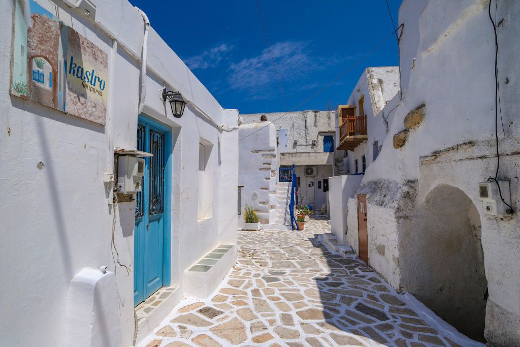 Street scenery of the narrow alleys around the walking path inside and around the old Venetian Castle and traditional whitewashed houses with trees and flowers in the town of Antiparos, Antiparos island, Cyclades islands, Aegean Sea, Greece (Photo by Nicolas Economou/NurPhoto via Getty Images)