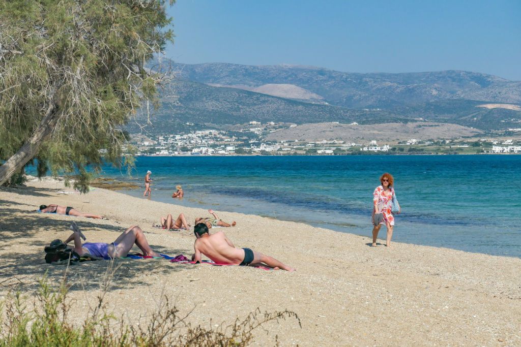 First Psaralyki or Psaraliki I is a public beach on Antiparos island, near Paros in Cyclades, Aegean Sea, Greece. The beach is popular for tourists and locals but not overcrowded as it is near the main town and the port in a walking distance. It is located in front of a lagoon, has flat crystal clear seawater, golden sand, shade trees and there are beach bars and water sports facilities or sunbed and pedal boats for rent. (Photo by Nicolas Economou/NurPhoto via Getty Images)