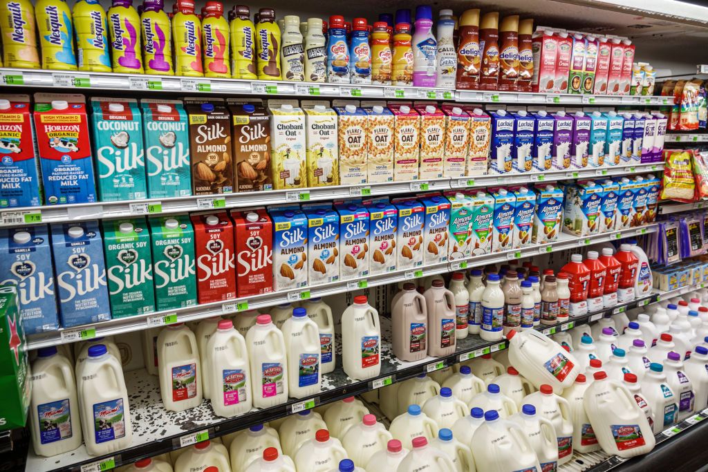 A supermarket’s refrigerated milk aisle, Silk, Nesquik, almond milk, organic milk, oat milk (Photo: Getty Images)