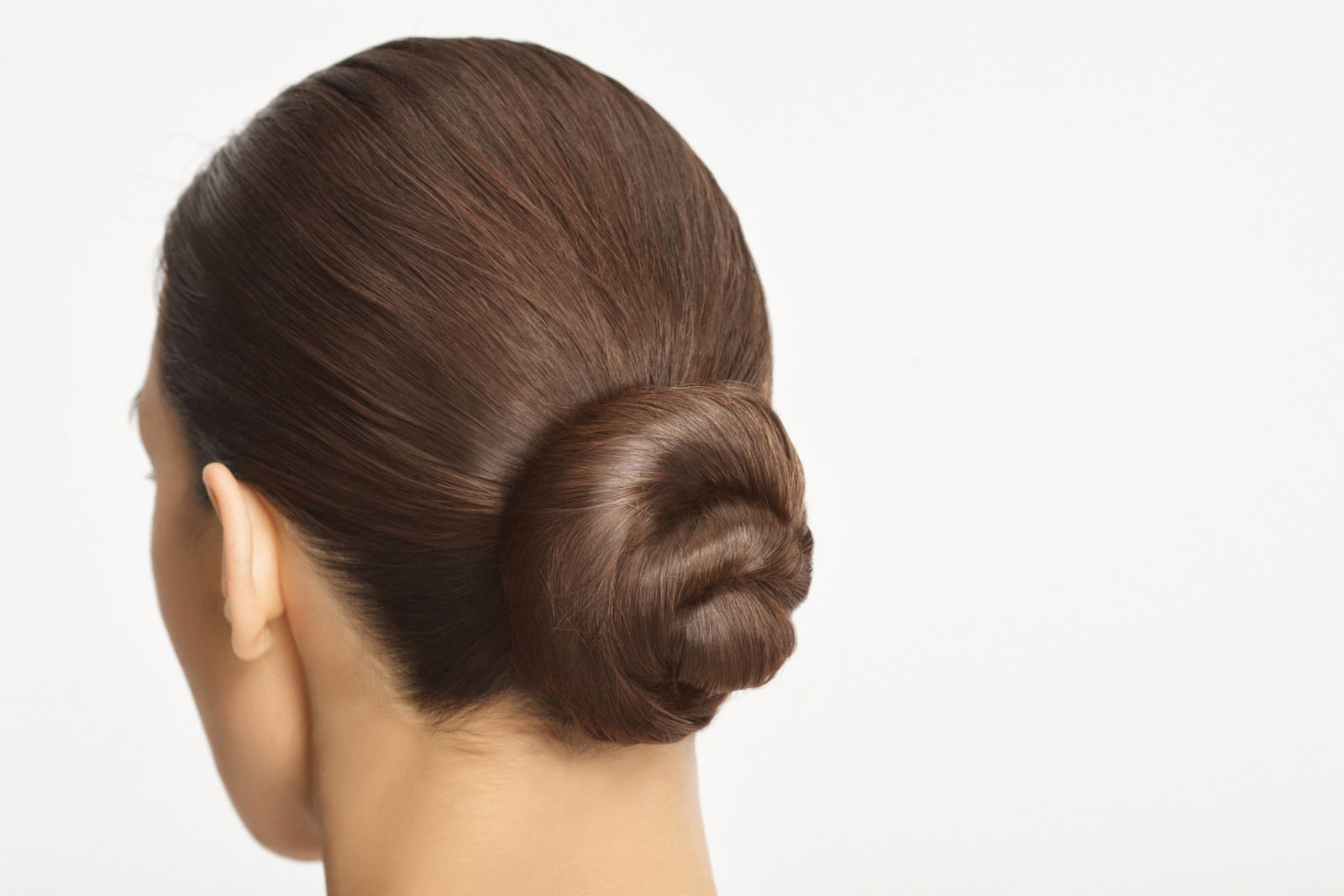 Natural Beauty. Rear view of a beautiful young woman with elegant hair bun, dark hair pulled up.