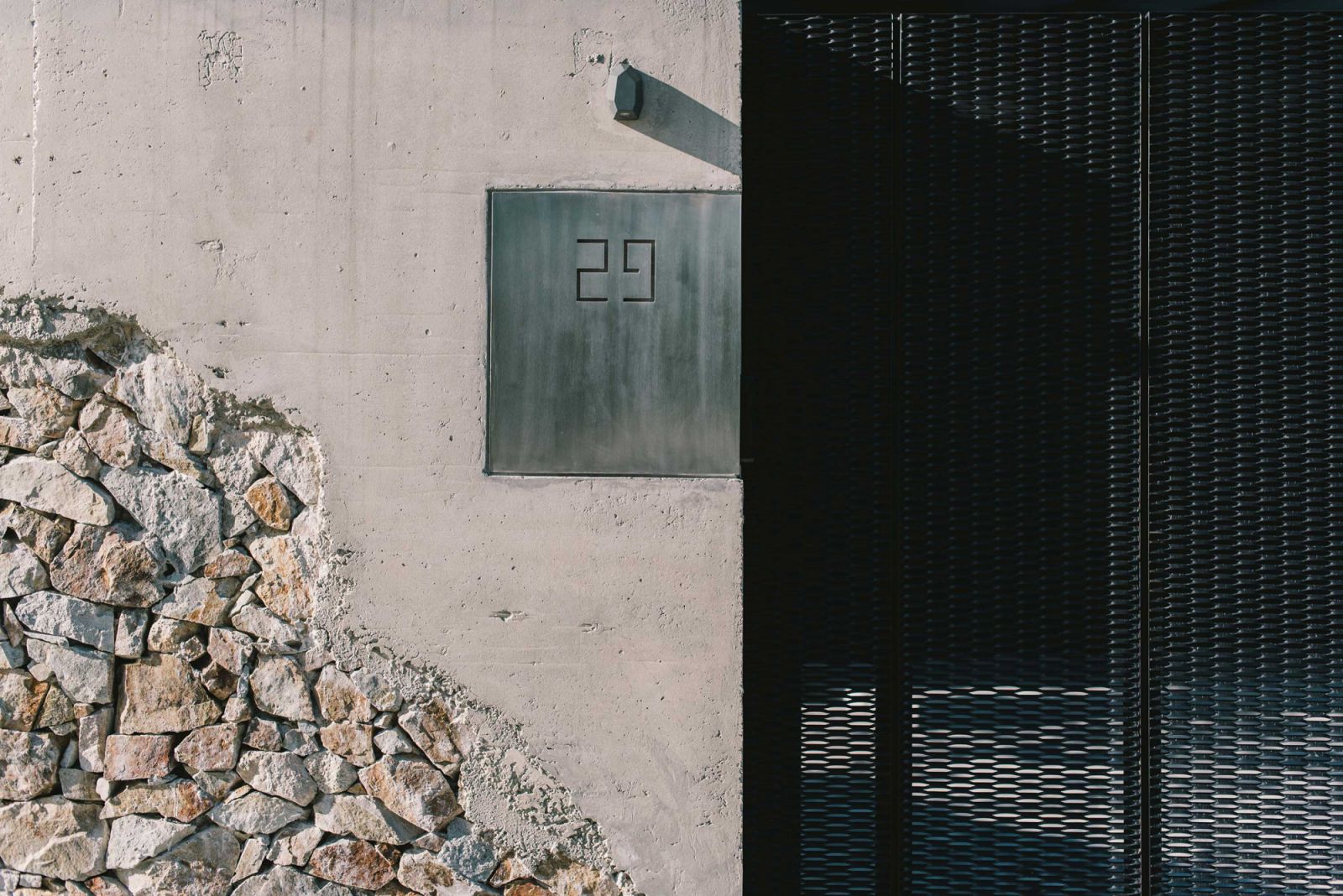 This raw aesthetic extends to the front gate