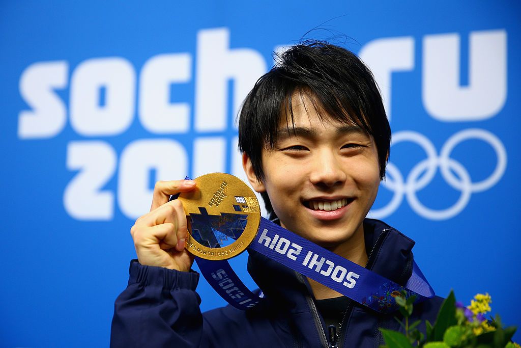 SOCHI, RUSSIA - FEBRUARY 15:  Gold medalist Yuzuru Hanyu of Japan celebrates during the medal ceremony for the Men's Figure Skating on day 8 of the Sochi 2014 Winter Olympics at Medals Plaza on February 15, 2014 in Sochi, Russia.  (Photo by Clive Mason/Getty Images)