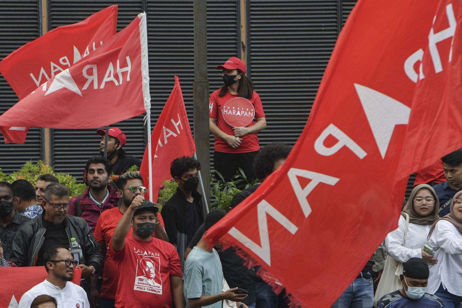 Anwar Ibrahim supporters hold Pakatan Harapan party flags as they celebrate Anwar swearing in as Prime Minister outside Istana Negara palace in Kuala Lumpur on 24 November 2022. (Photo by Mat Zain/NurPhoto via Getty Images)