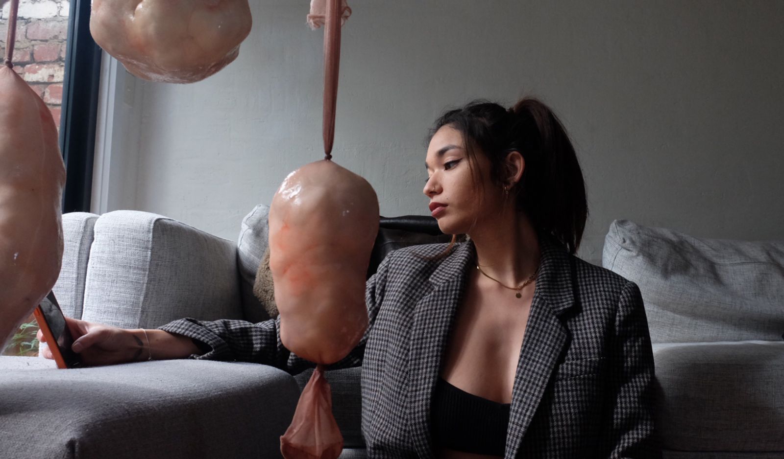 The artist, Kara Inez, poses alongside her works (Image: courtesy of Kara Inez)