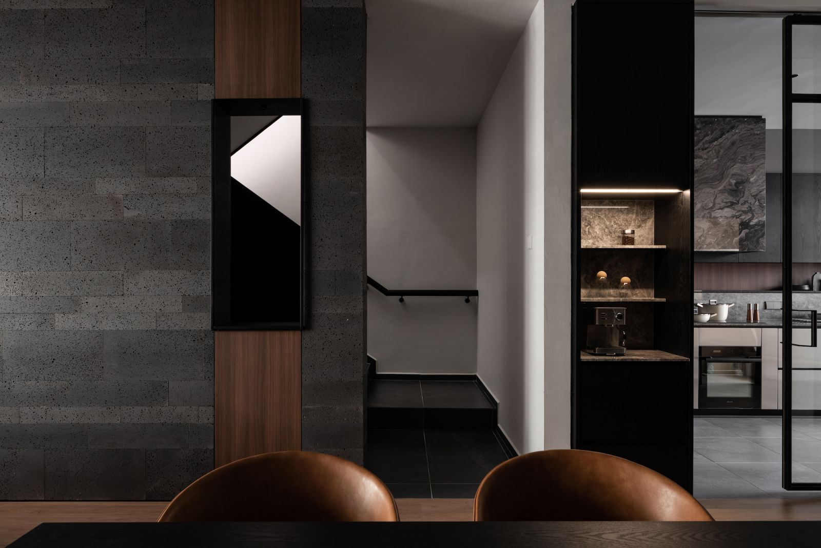 Glass panels divide the living and kitchen