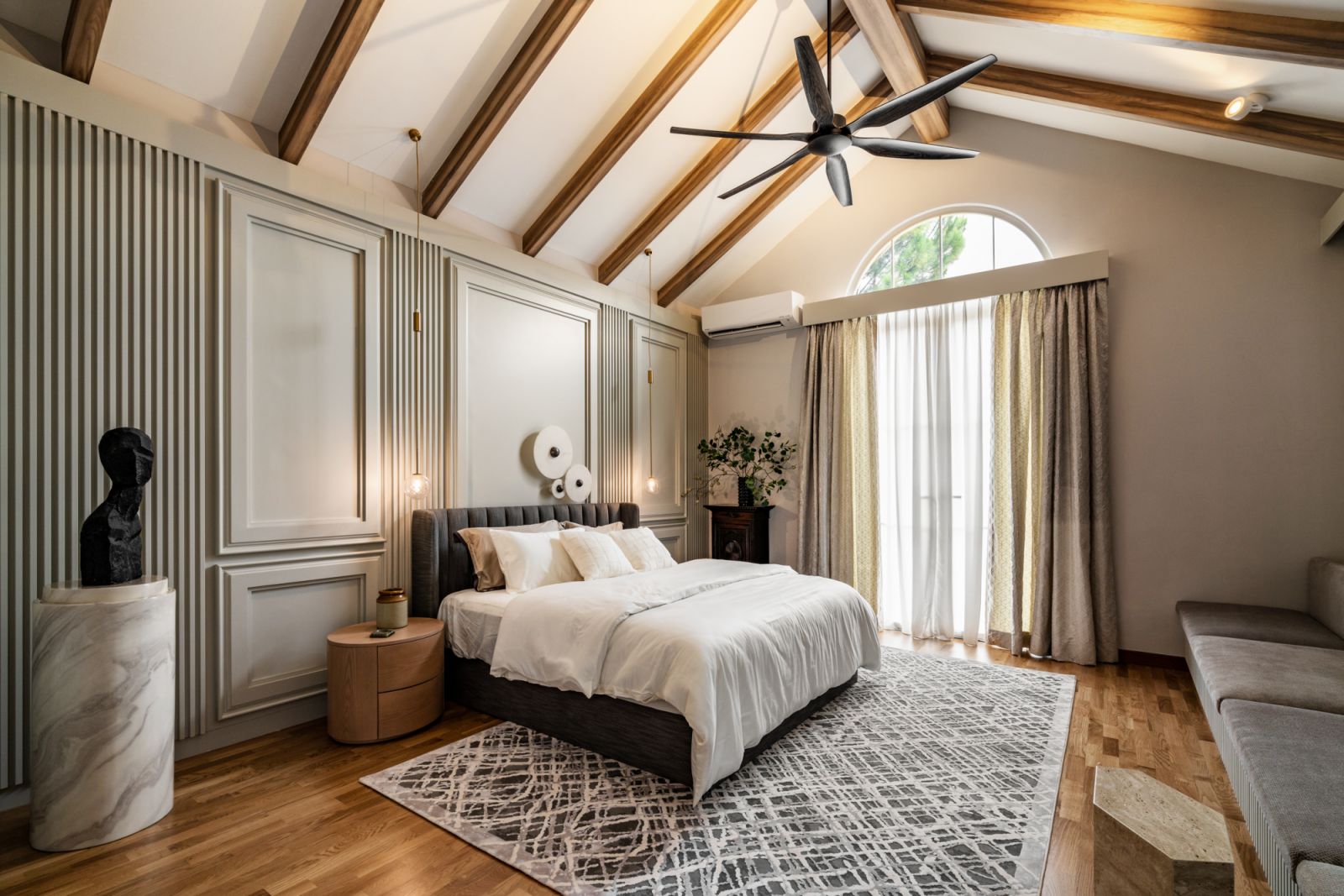 The bedroom has exposed ceiling beams for a rustic effect