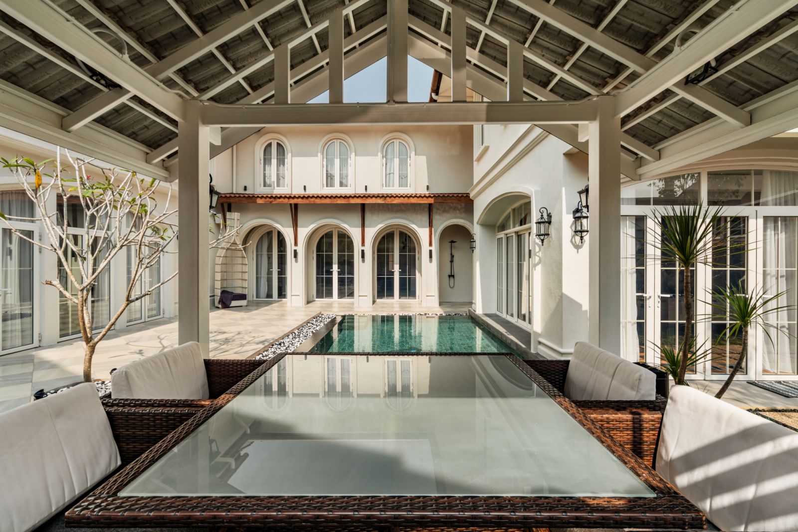 Timber trusses frame the poolside