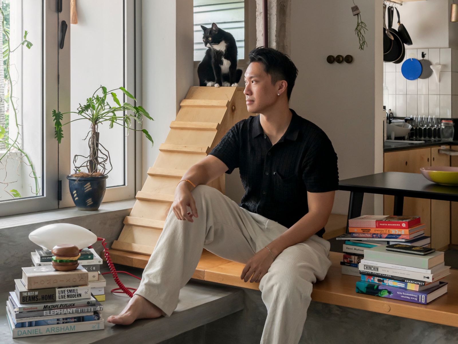 Jun Ong, co-founder of POW Ideas and Jasper, tuxedo cat (Photo: David Yeow)
