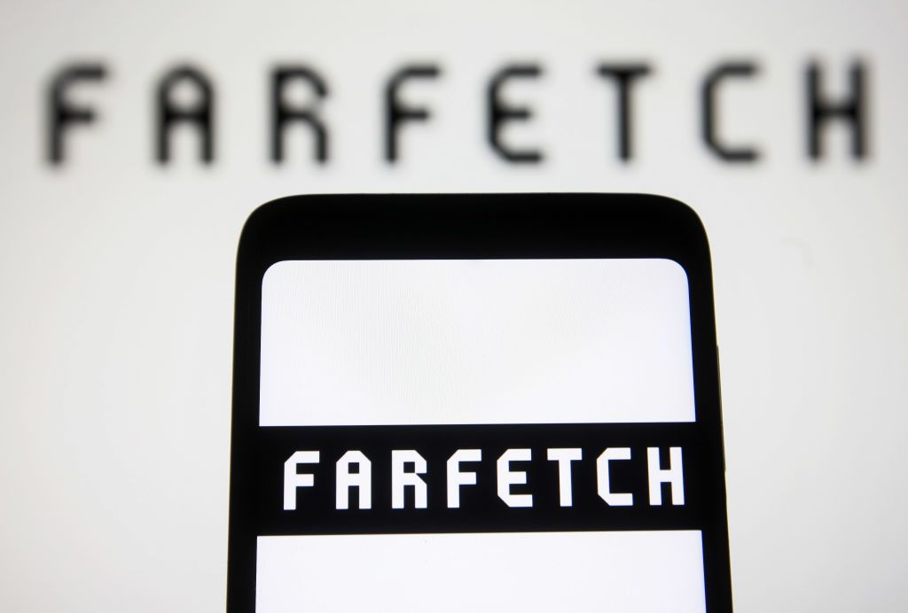 UKRAINE - 2022/01/28: In this photo illustration, the Farfetch logo is displayed on a smartphone screen and in the background. (Photo Illustration by Pavlo Gonchar/SOPA Images/LightRocket via Getty Images)