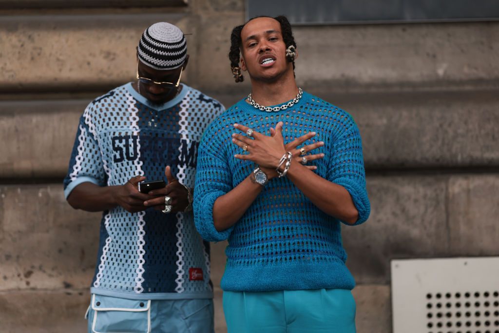 PARIS, FRANCE - JUNE 21: Fashion Week guest is seen wearing a transparent Supreme blue logo shirt, blue Cargo pants and knit blue striped hat the other one is wearing a silver chain, Audemars Piguet watch and blue outfit outside Wales Bonner during the Menswear Spring/Summer 2024 as part of Paris Fashion Week on June 21, 2023 in Paris, France. (Photo by Jeremy Moeller/Getty Images)