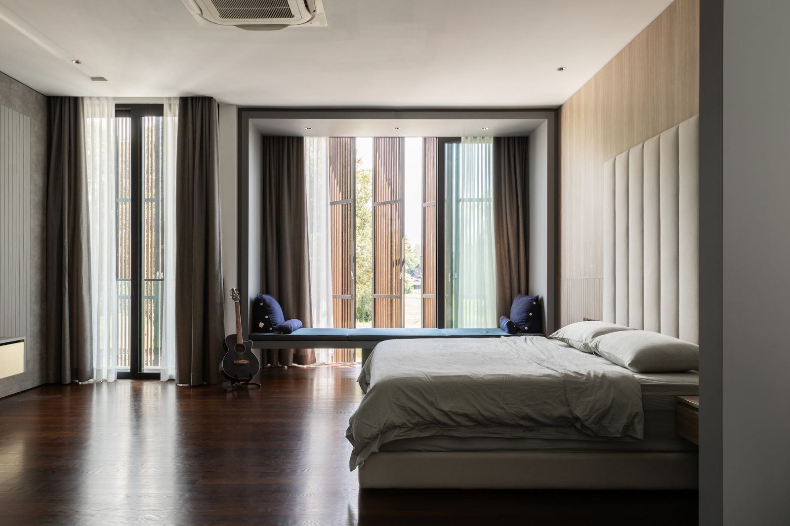 The bedroom has clean lines but a cozy feel