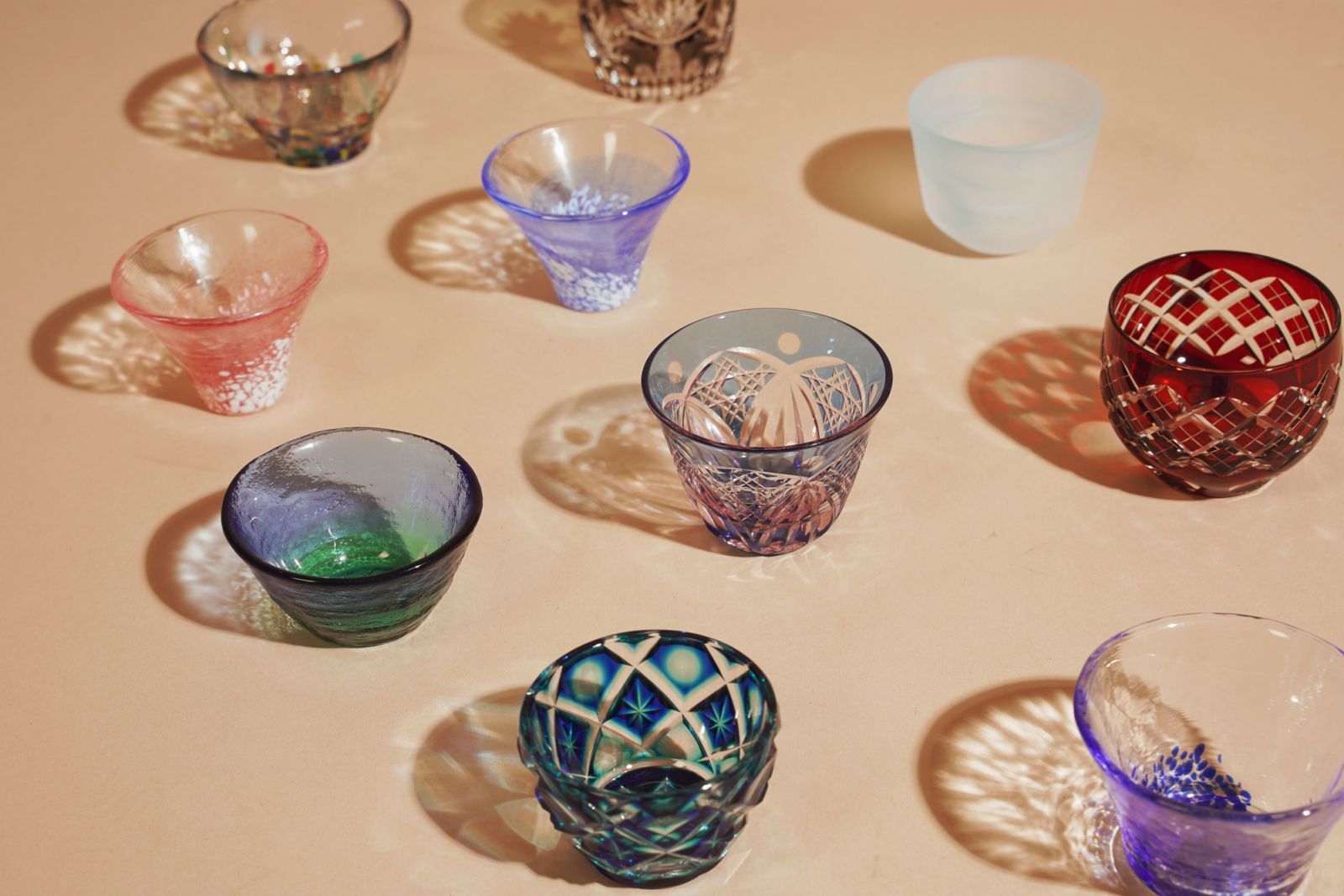 An array of saké cups made from both cut and blown glass