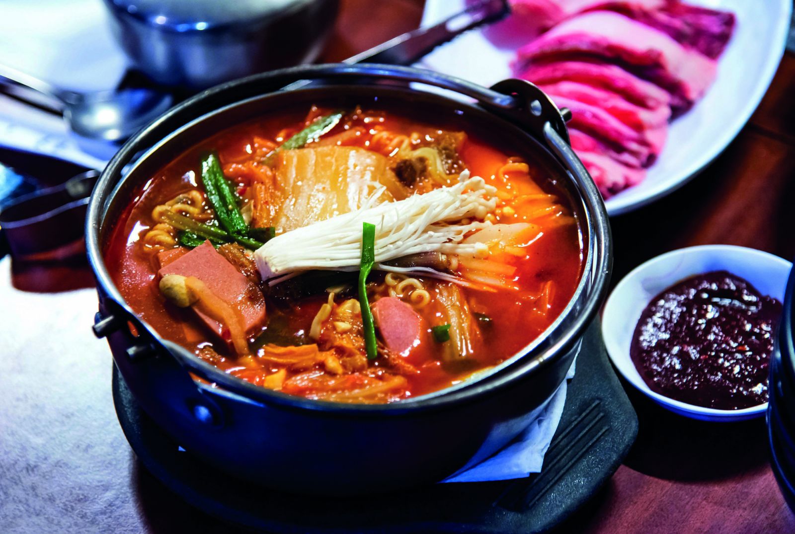 RK4XDJ Korean spicy sausage stew with vegetables close up