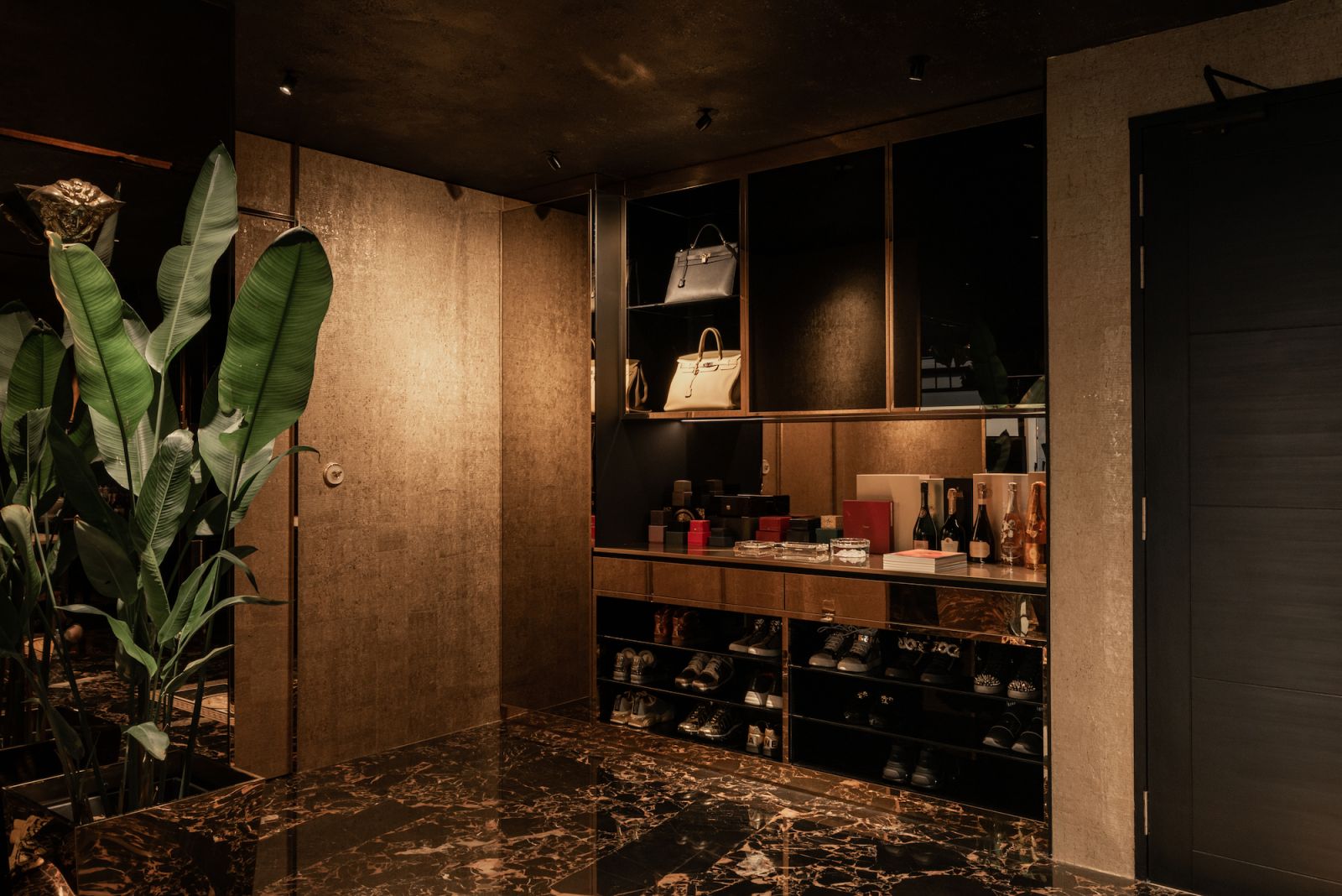The entryway was designed with built ins to neatly display and house the client’s various collections
