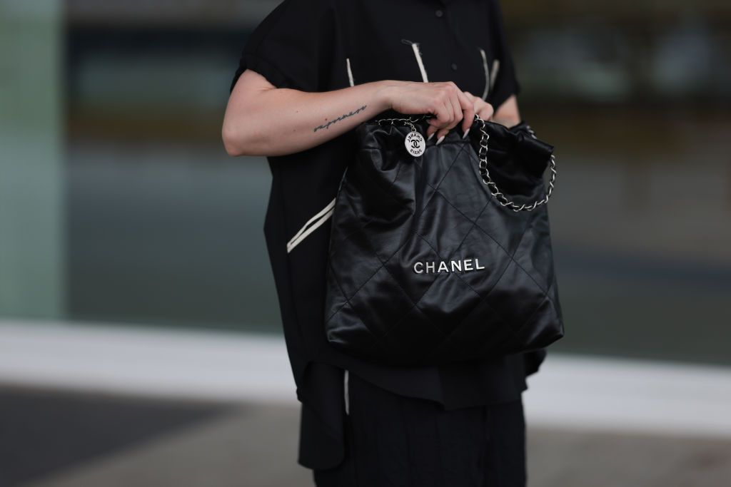 COLOGNE, GERMANY - AUGUST 17: Maria Barteczko seen wearing WENDYKEI black button down shirt with pockets, WENDYKEI black winkled effect wide leg pants, Chanel 22 black hobo leather shopper bag, on August 17, 2023 in Cologne, Germany. (Photo by Jeremy Moeller/Getty Images)