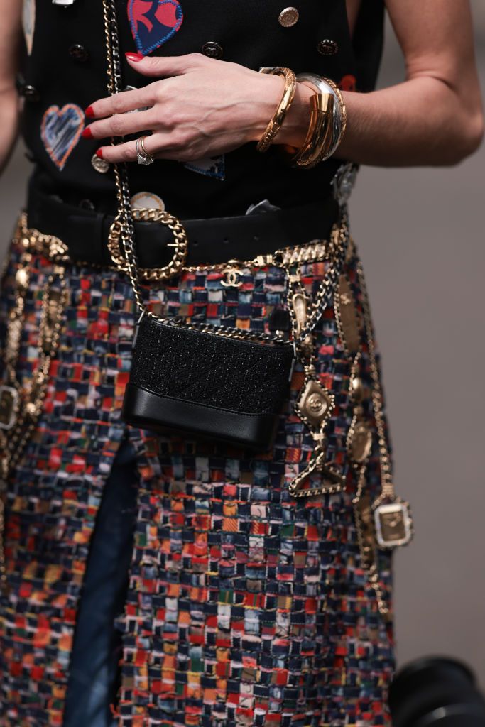 PARIS, FRANCE - JULY 04: Maria Helena Bordon Meireles seen outside Chanel show wearing Chanel earrings, black sunnies, Chanel logo tank top in black, Chanel belt, Chanel Gabrielle handbag, Chanel tweed skirt and Chanel logo pair of jeans underneath, black plateau heels during the Haute Couture Fall/Winter 2023/2024 as part of  Paris Fashion Week on July 04, 2023 in Paris, France. (Photo by Jeremy Moeller/Getty Images)