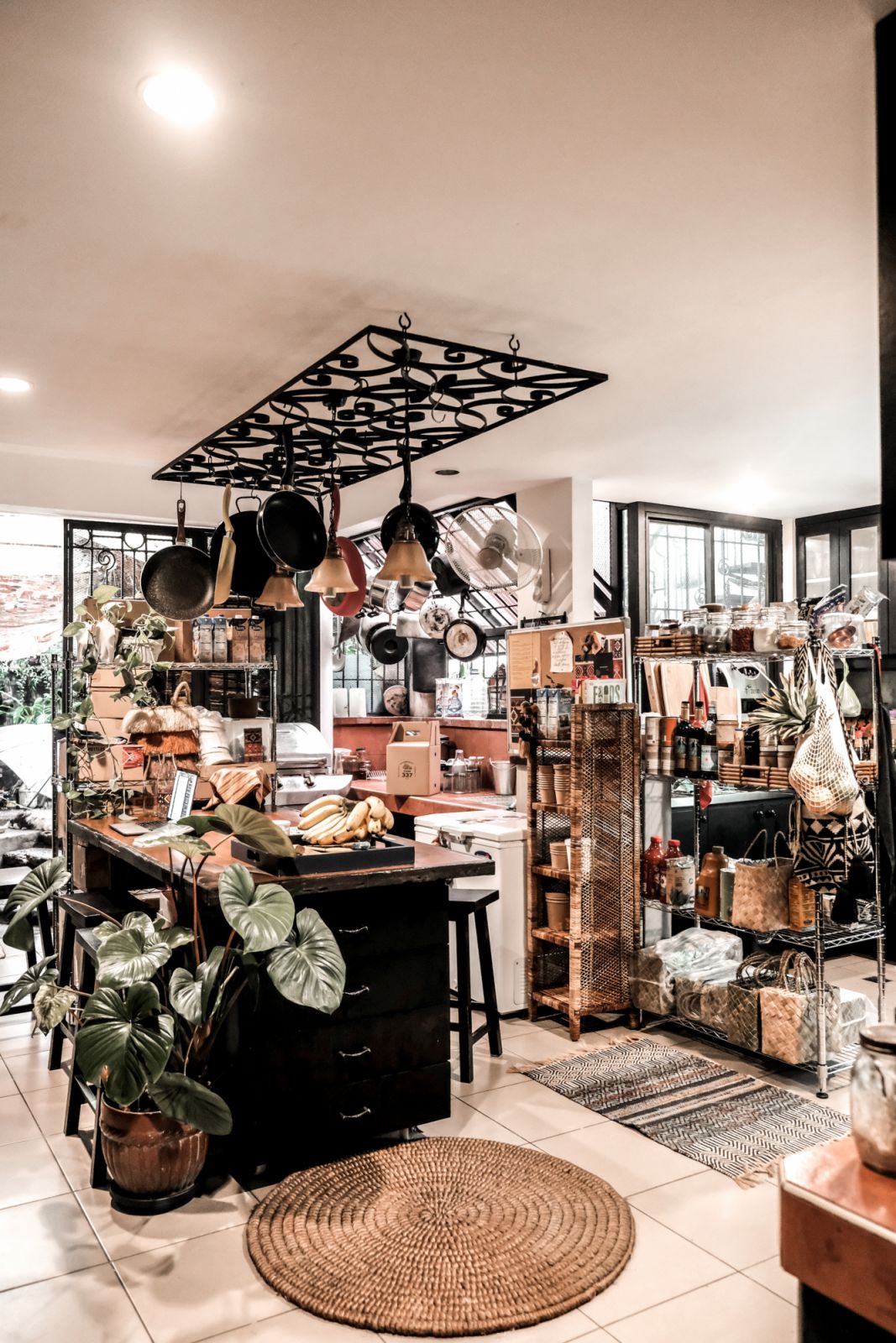Expert layering can be felt and seen even in the kitchen, as pots and pans co-exist along with lush plants