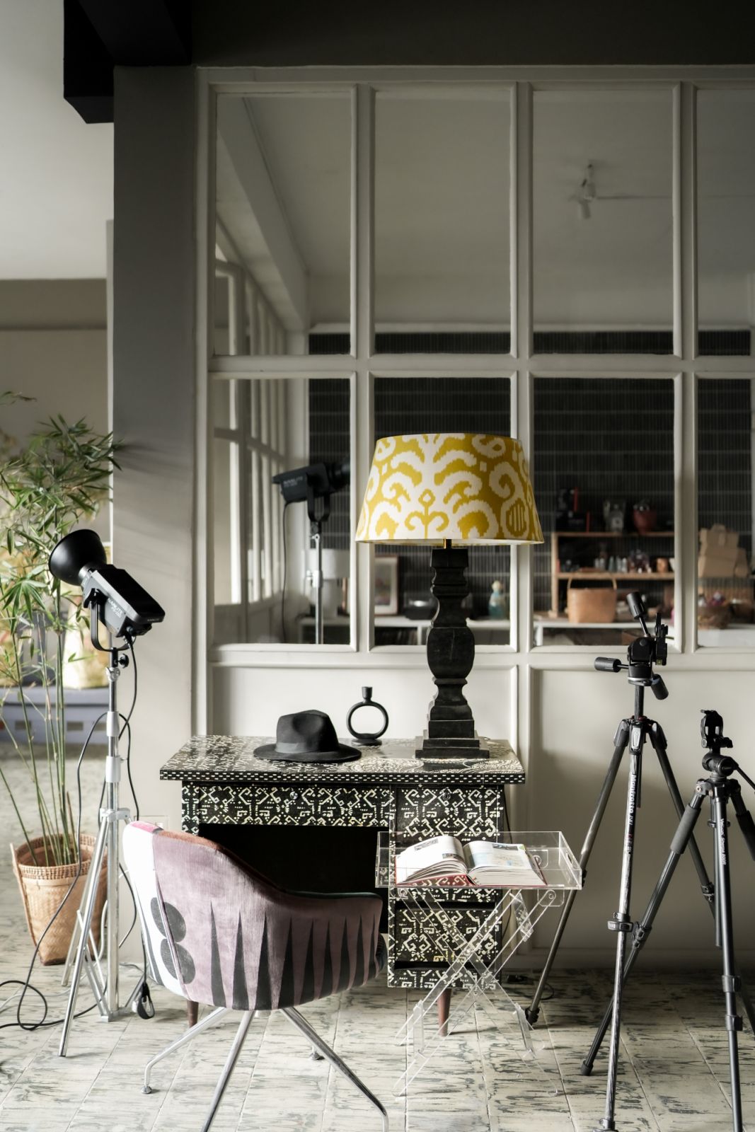 In her work studio, a restored mid-century swivel chair pairs nicely with a lamp from Solano