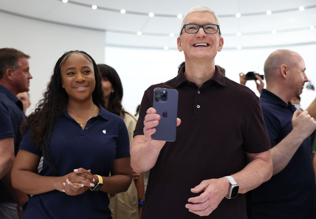 CUPERTINO, CALIFORNIA - SEPTEMBER 07: Apple CEO Tim Cook looks at a new iPhone 14 Pro during an Apple special event on September 07, 2022 in Cupertino, California. Apple unveiled the new iPhone 14 as well as new versions of the Apple Watch, including the Apple Watch SE, a low-cost version of the popular timepiece that will start at $249. (Photo by Justin Sullivan/Getty Images)