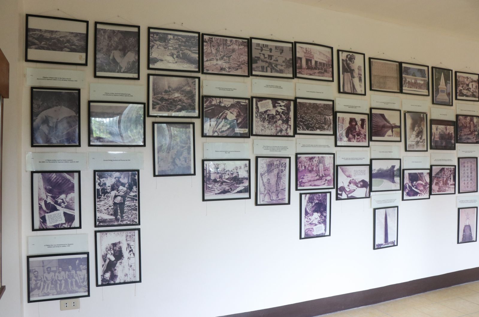 A wall of World War II photographs at the Bataan World War II Museum