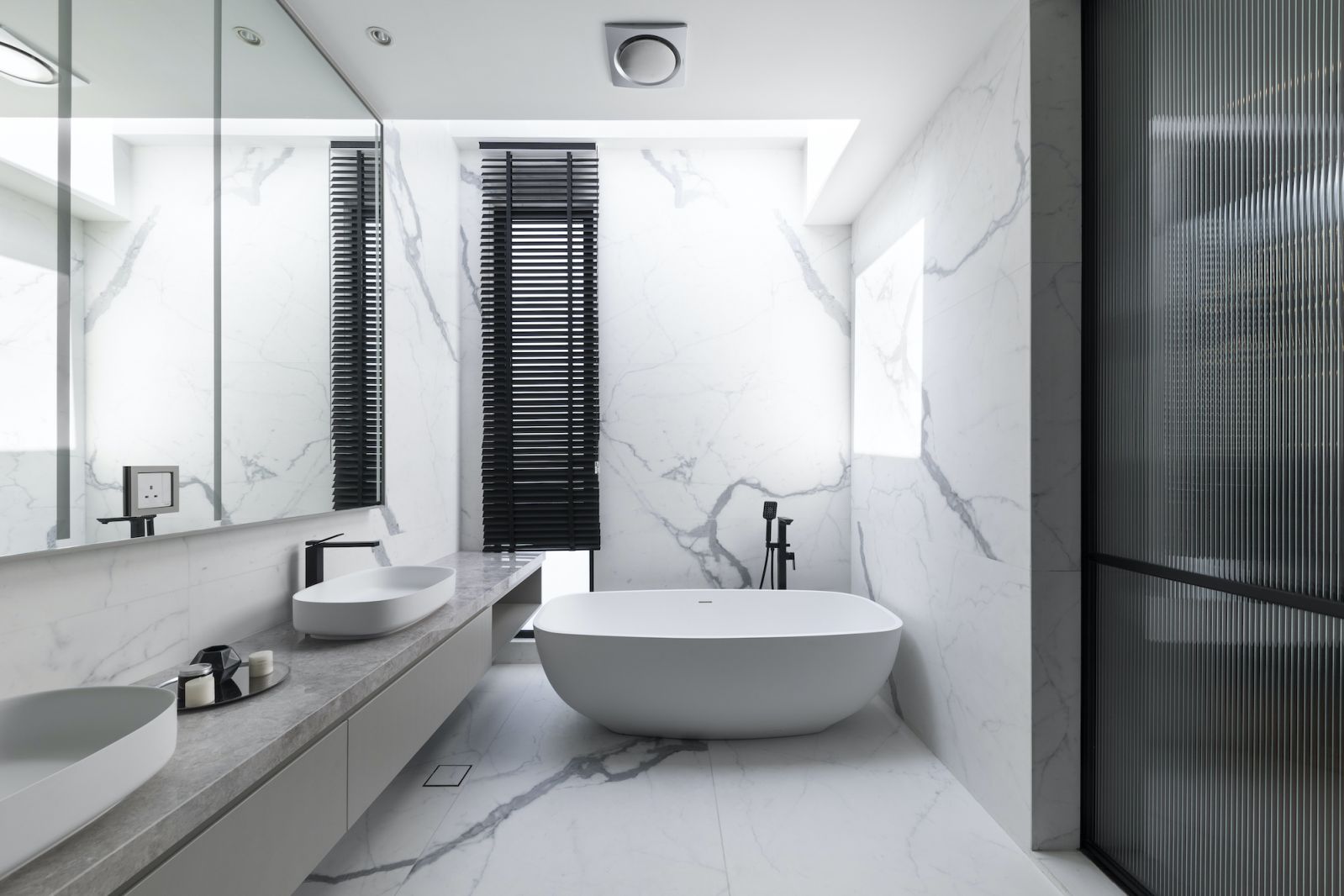 The large walk-in wardrobe opens up to the luxurious bathroom