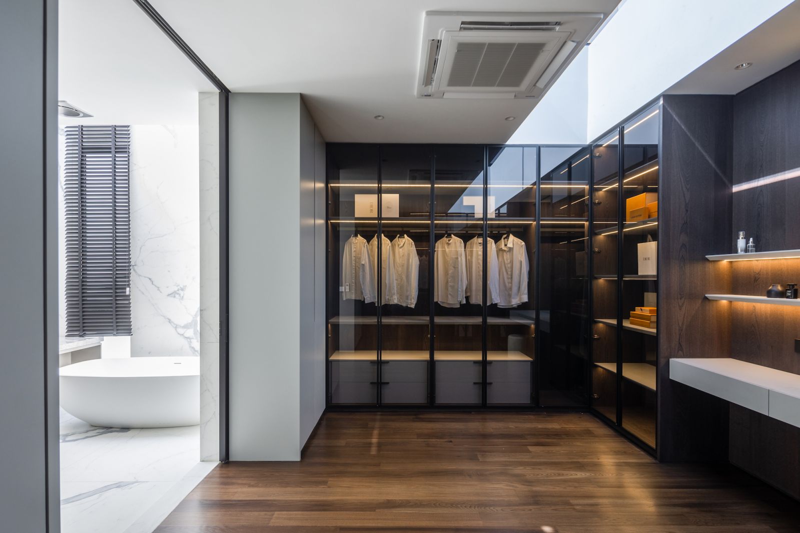 The large walk-in wardrobe opens up to the luxurious bathroom