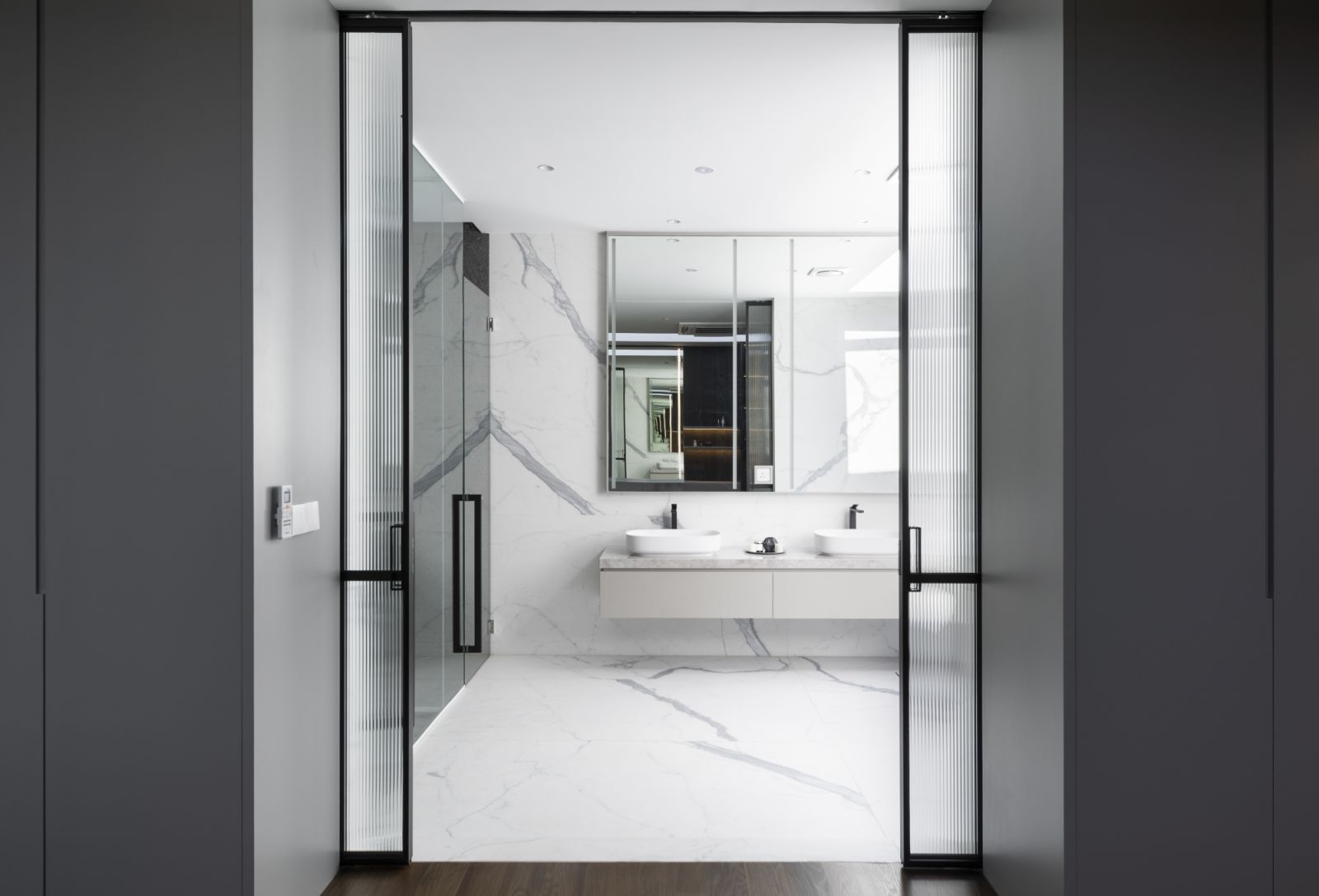 The large walk-in wardrobe opens up to the luxurious bathroom