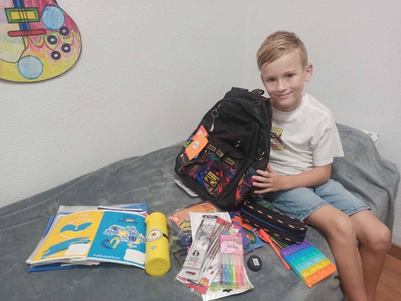 Pilip, 9, from Mariupol, Ukraine received a tablet and supplies that he uses for school this September
