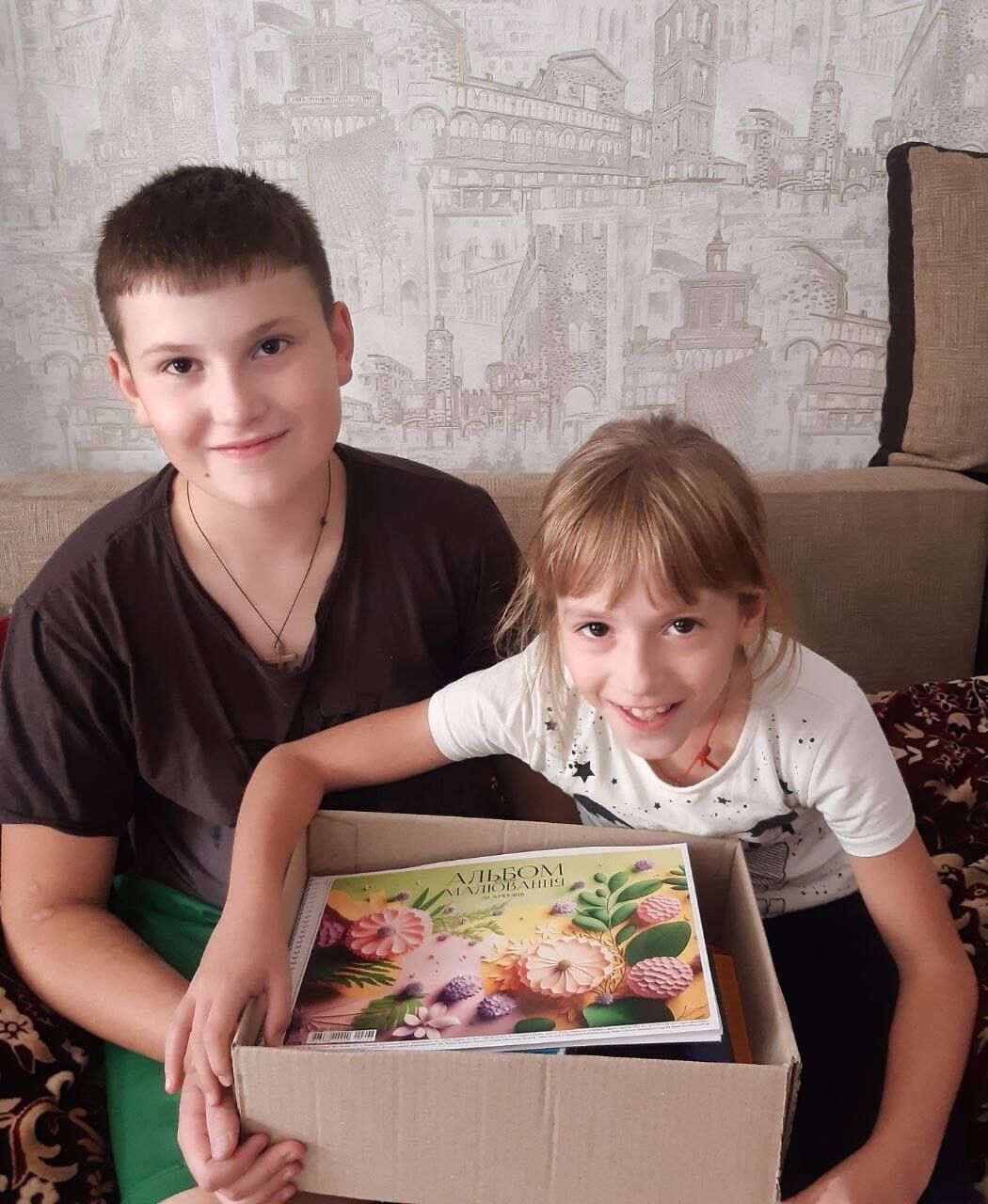 Volodymyr, 12, and Natalia, 8 from Stovpin, Rivne region consider this box of supplies as a valuable addition to their school days