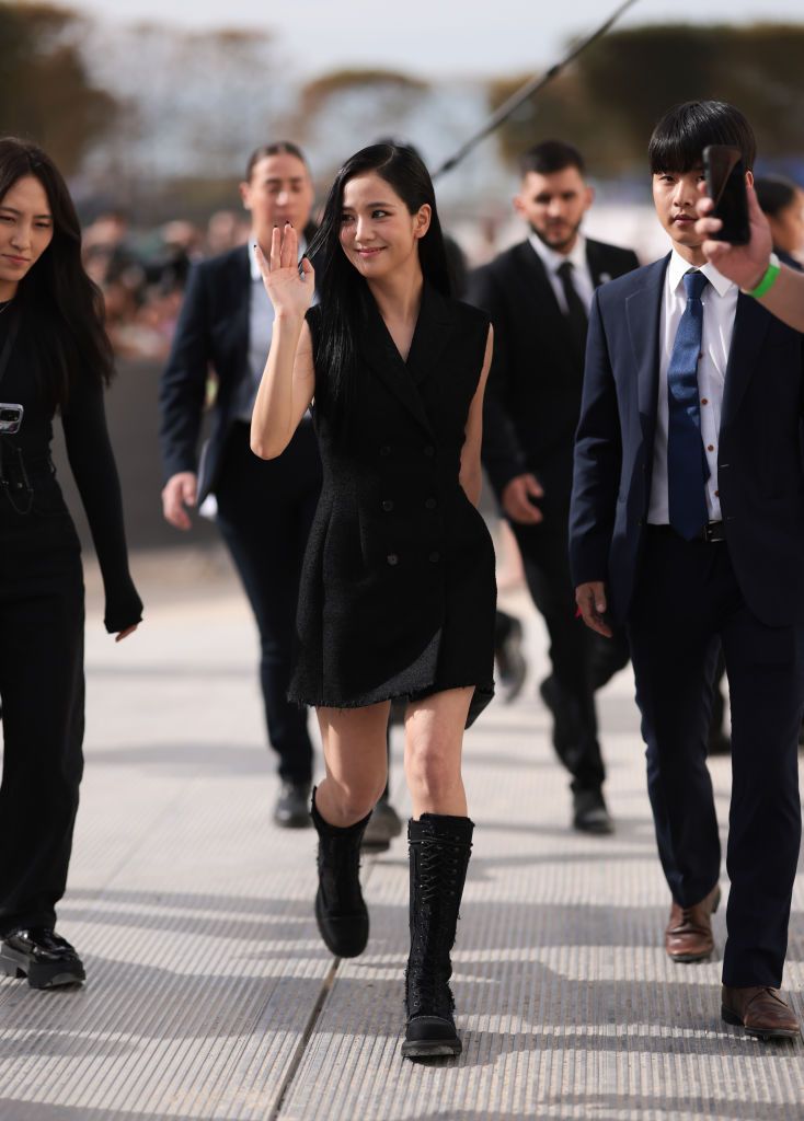 PARIS, FRANCE - SEPTEMBER 26: Jisoo of Blackpink is seen wearing a complete outfit from Christian Dior, consisting of a sleeveless, black wool, mini dress with lapel collar and V-neck; a black leather handbag and knee-high, laced-up, black fabric boots before the Christian Dior Womenswear Spring-Summer 2024 Show as part of Paris Fashion Week on September 26, 2023 in Paris, France. (Photo by Jeremy Moeller/Getty Images)