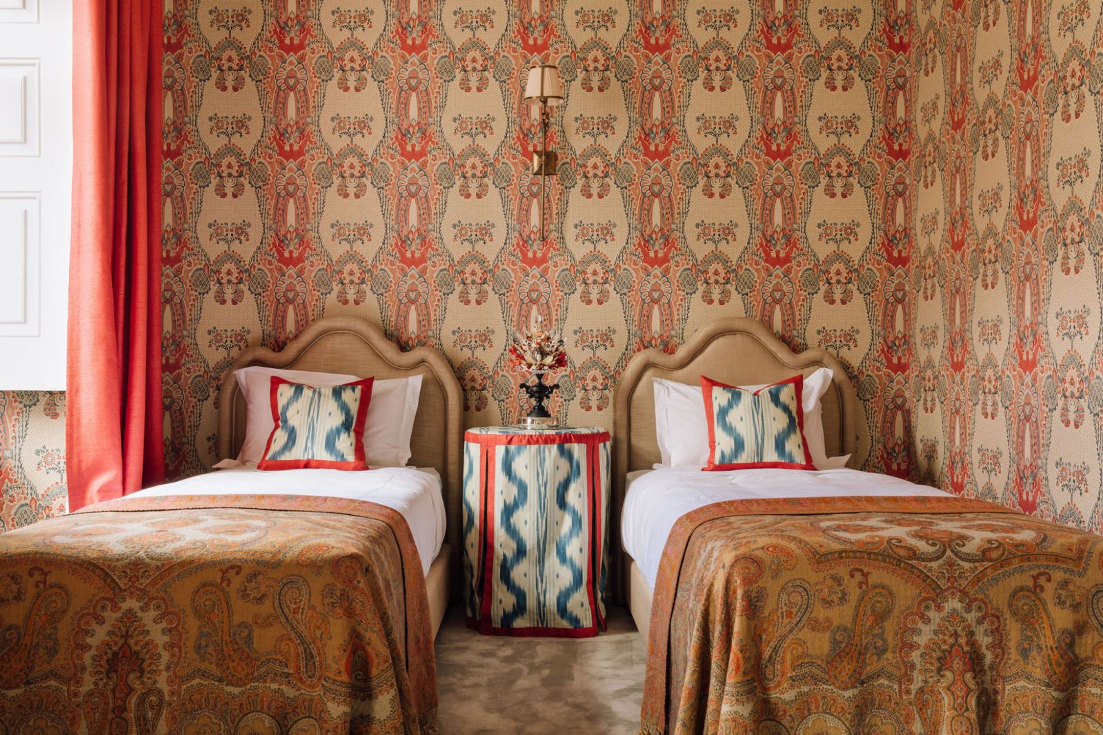 indian inspired wallpaper and sheets with two beds and side table