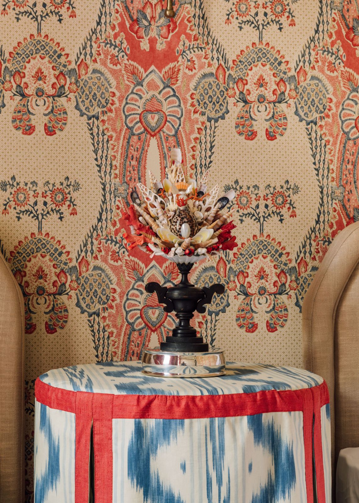 ornamental piece on side table next to bed made of seashells and coral