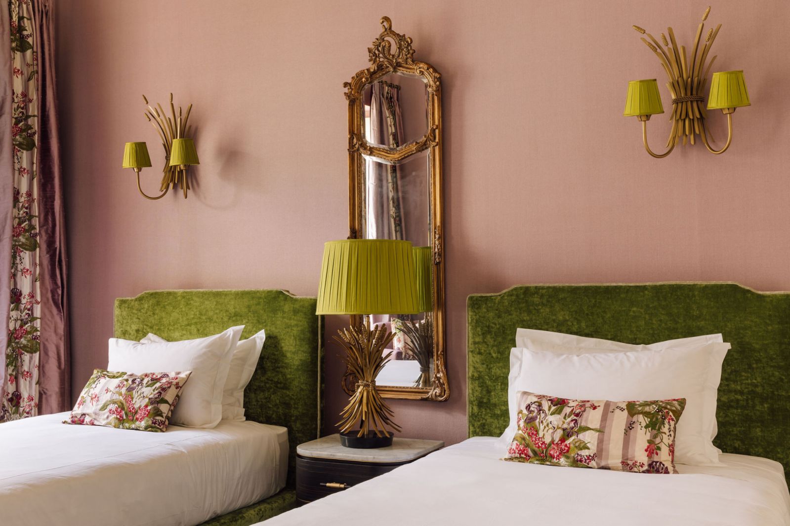 two beds and two ornamental lamps on wall