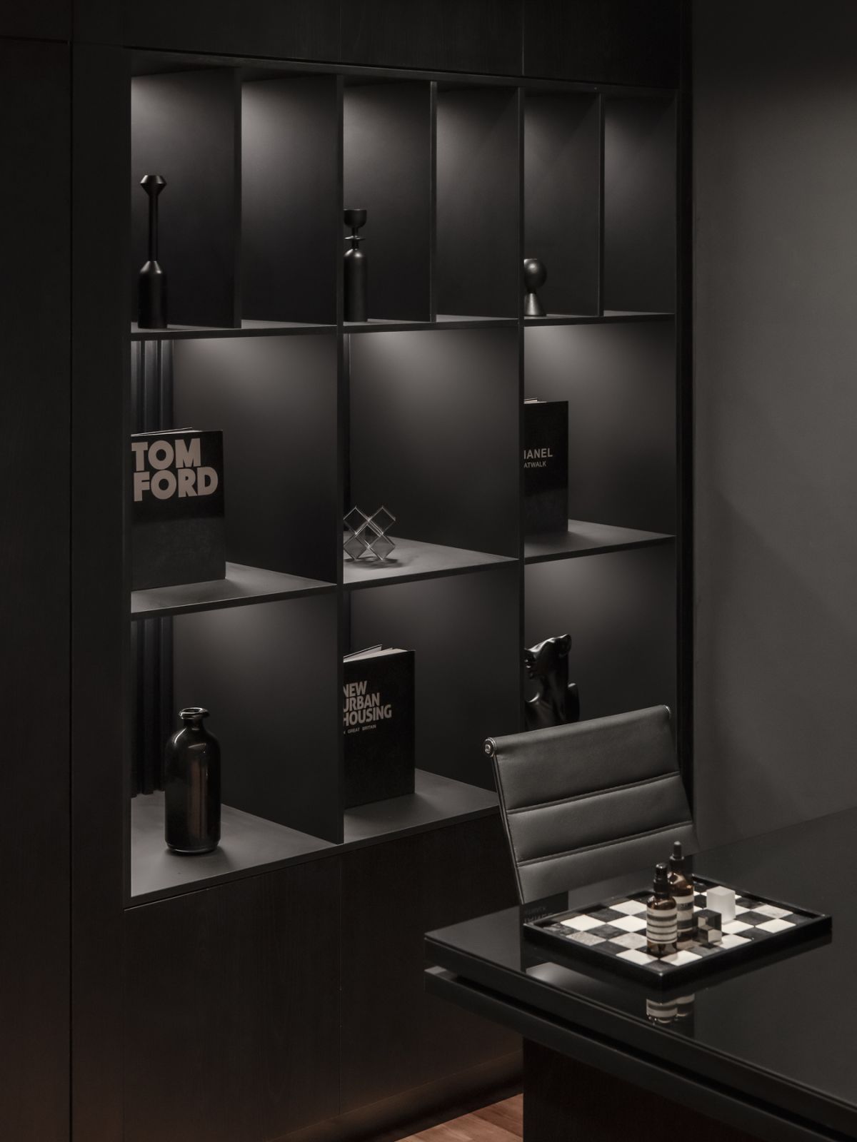Simple details are emphasised against the black walls and shelving