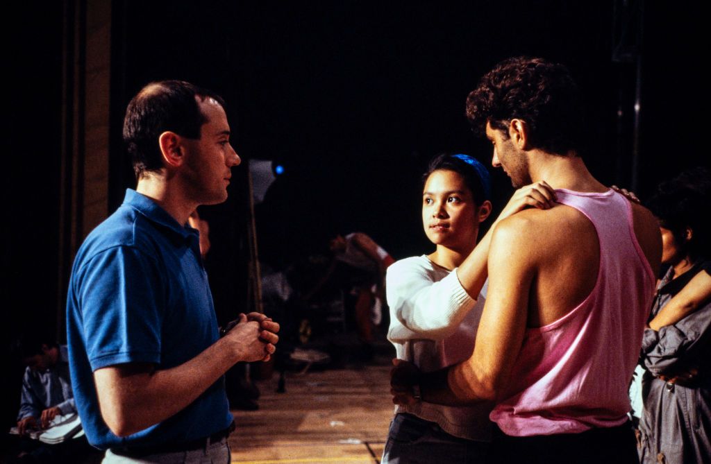 LONDON - SEPTEMBER 18: Film and Theatre director Nicholas Hytner directs singer Lea Salonga in rehearsals for the hit musical "Miss Saigon" in the Theatre Royal, London, England on September 18, 1989. (Photo by David Levenson/Getty Images)