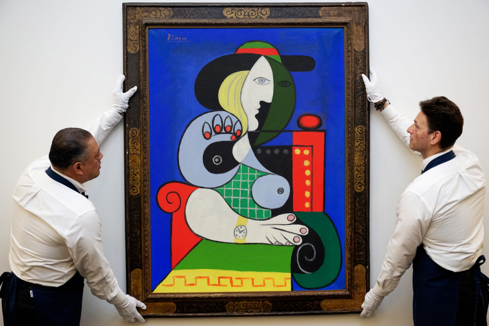 NEW YORK, NEW YORK - SEPTEMBER 11: Sothebyâs art handlers adjust Pablo Picassoâs âFemme à la montreâ from the Emily Fisher Landau Collection during an unveiling at the Breuer Building in New York City on September 11, 2023 in New York City. (Photo by Alexi J. Rosenfeld/Getty Images for Sotheby's)