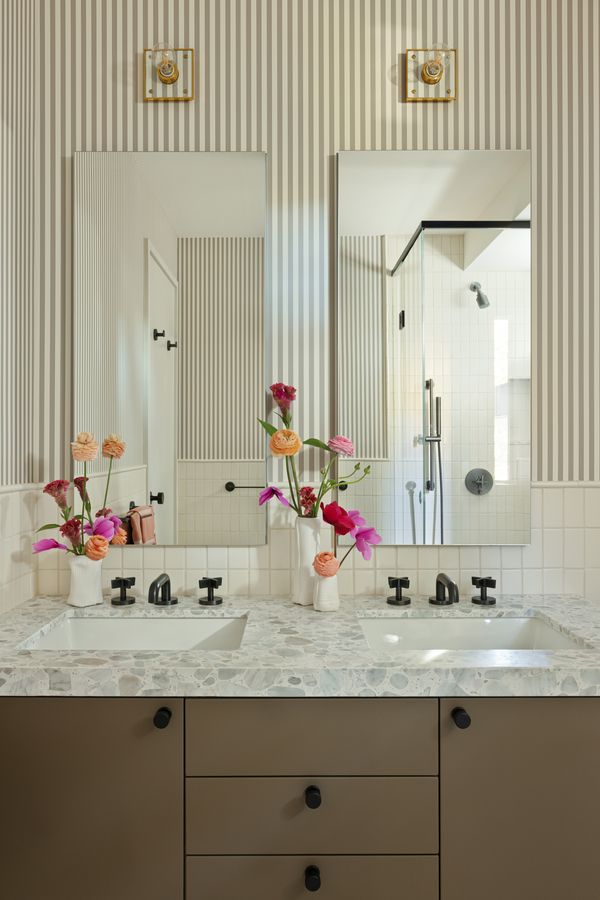 The pinstripe wallpaper provides a retro touch to this bathroom