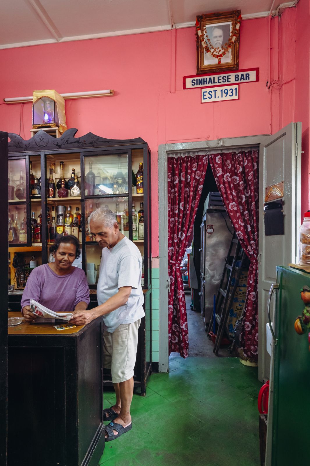 Perera and his wife, Kamalavathy, by the bar’s famed liquor cabinet