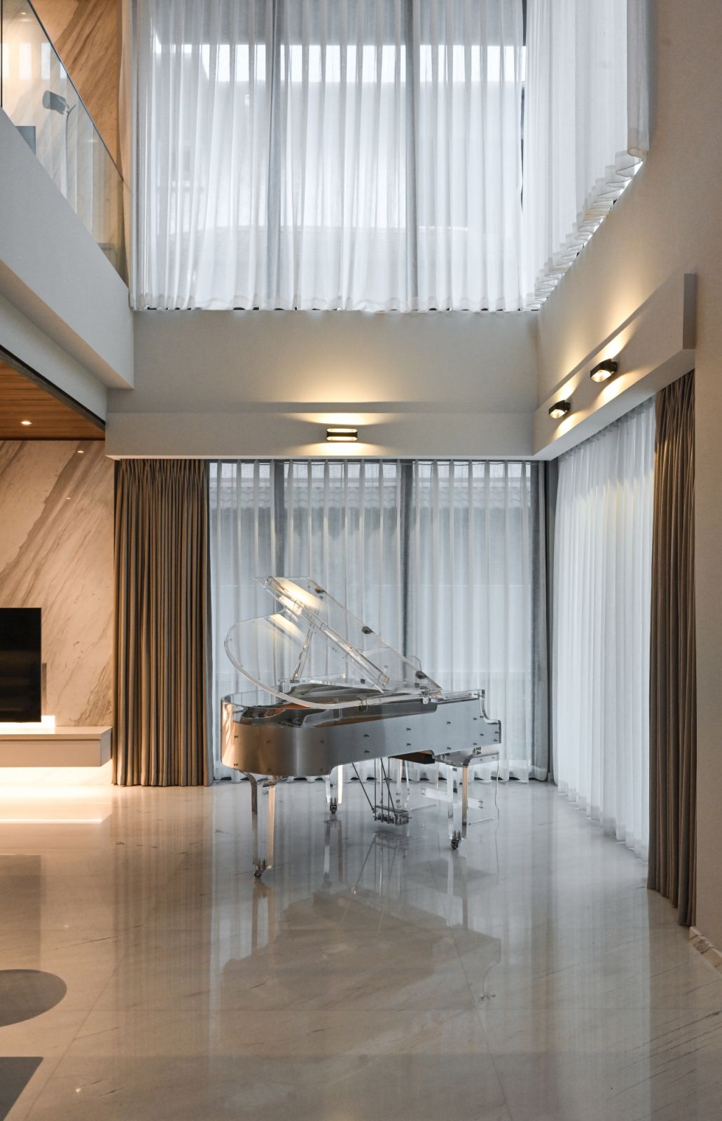 A transparent grand piano takes pride of place