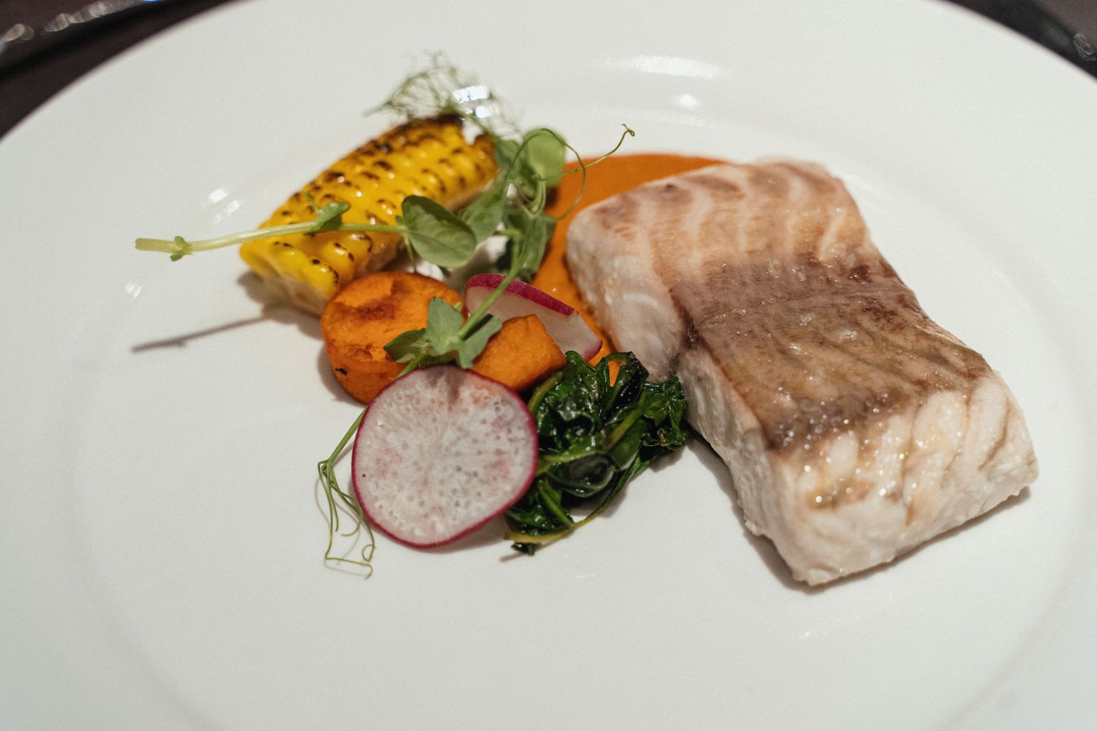 Barramundi with confit sweet potato cooked Vizcaina style